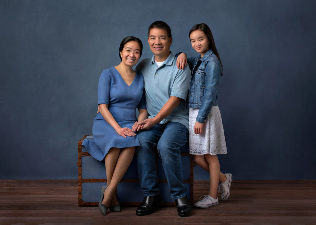 Vietnamese family with daughter studio fine art family portrait blue color scheme family photoshoot indoors