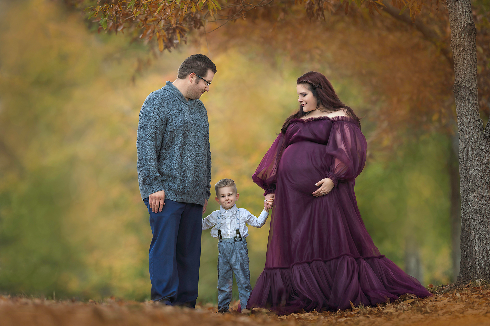 family of three maternity session with little boy fine art outdoor portrait maternity photoshoot fall colors couture maternity gown